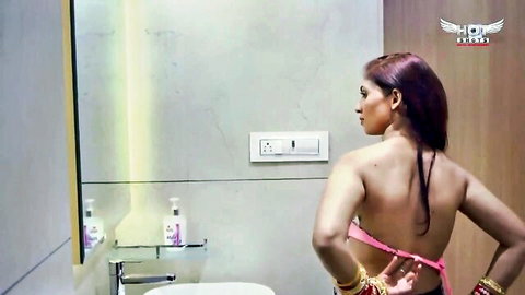 Sexy Desi Bhabhi in pink saree showing bare back in steamy honeymoon scene