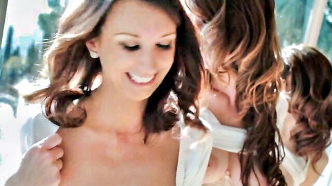 Two topless brunettes with medium tits smiling intimately while embracing outdoors
