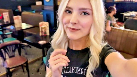 Eva Elfie blonde smiling selfie in California t-shirt at bar