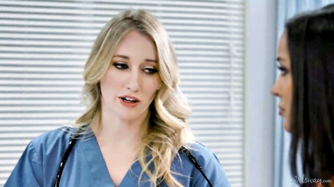 Blonde nurse in scrubs chats with brunette in office - lesbian scissoring teaser