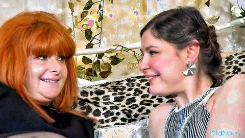 BBW redhead and brunette smiling intimately close-up on leopard bed