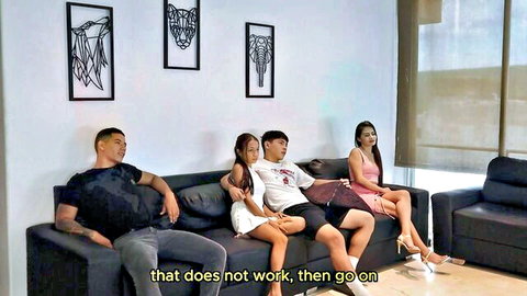 Muscular tattooed Asian hunk caresses petite girlfriend's bare thighs on couch with stepson and e-girl