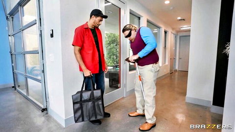 Blind man with white cane stands with red-shirted guy holding bag in modern hallway Brazzers tease