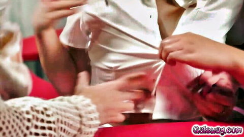 Busty Asian woman in white shirt unbuttoned by multiple hands exposing her big tits