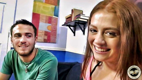 Smiling redhead teen couple in casual clothes posing happily on webcam