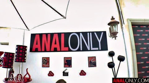 Anal only studio room decorated with bold red ANALONLY banners and retro lamps