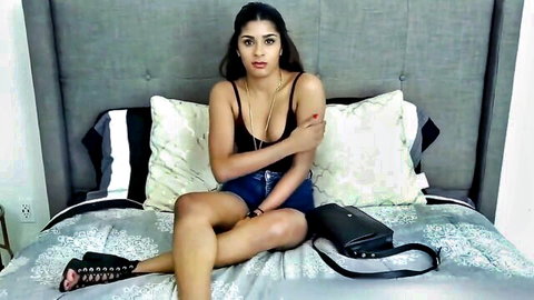 Sexy Indian model in fake casting, short shorts and tank top, teasing pose