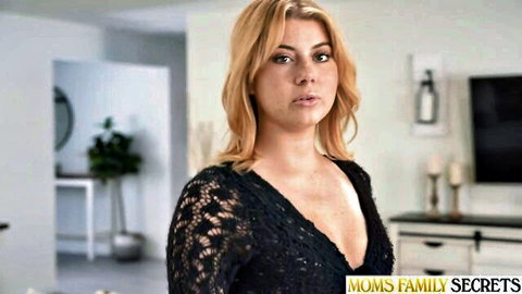 Blonde MILF in low-cut black lace top teasing massive cleavage from Moms Family Secrets
