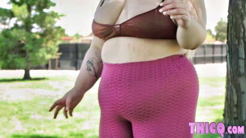 Thick BBW babe with huge tits and fat ass in tight pink leggings and brown bikini top smoking outdoors