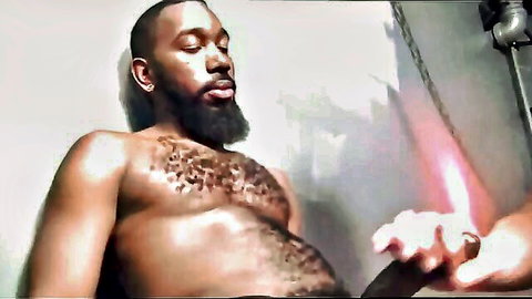 Muscular bearded black man with hairy chest gets handjob on massive erect cock