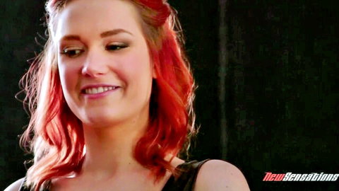 Smiling addictive redhead in black top, close-up from New Sensations adult video