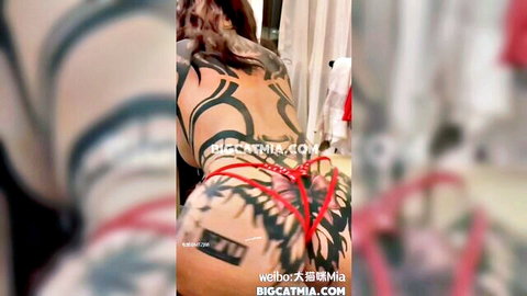 Bigcat Mia tattooed Asian beauty in red straps showing big ass