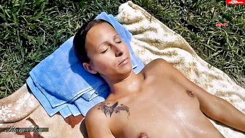 Klara-Play nude sunbathing outdoors with chest tattoo