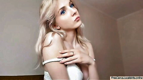 Cute blonde camgirl with beautiful blue eyes teasing in white lingerie