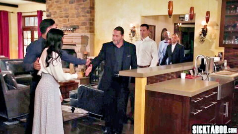 Penelope Woods as big ass MILF greeting suited men in kitchen scene