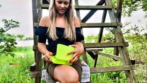 Bibixxx teases in public park, blonde in off-shoulder top and skirt outdoors