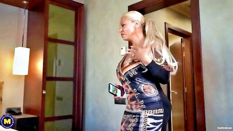 Blonde MILF Alexa Blun in plunging dress showing deep cleavage