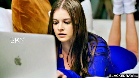 Sky Wonderland in blue dress lounging with laptop, curvy tease