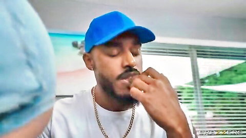 Lissa Aires in blue nurse scrubs with black man in cap, thoughtful pose