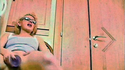 Blonde MILF in glasses masturbates with purple dildo on chair