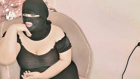 Curvy Arab MILF in niqab and sheer top exposing big tits, seductive pose