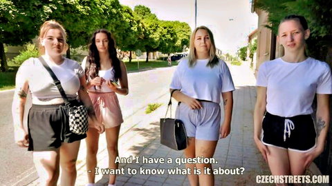 Four Czech blondes in shorts and tees strolling urban street, public tease