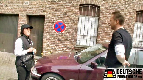 German amateur police uniform scene with woman officer and man by red car