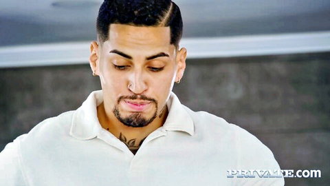 Tattooed Latino hunk in white polo shirt stares down in Angie Lynx influencer scene
