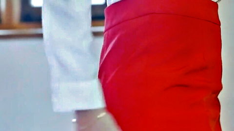 Blonde flight attendant in tight red skirt and white blouse posing