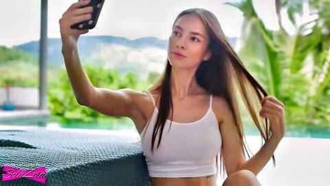 SolaZola sexy poolside selfie in white tank top, slim Asian beauty