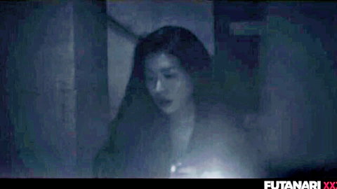 Mysterious Asian brunette with long hair holds glowing light in dark room