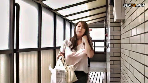 Yumi Kazama in white top and skirt, mature Japanese MILF in hallway