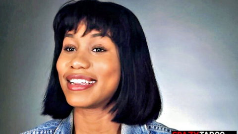 Smiling ebony babe with bob haircut and bangs in denim jacket closeup