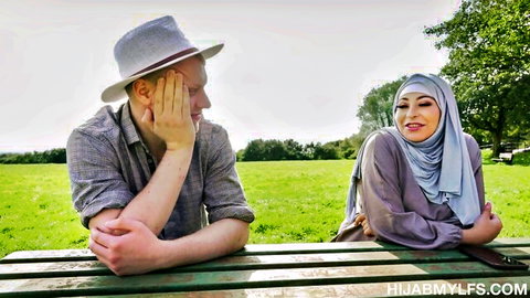 Chris Cobalt flirts with smiling Arab beauty in hijab outdoors