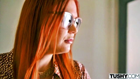 Redhead MILF with glasses smirks seductively in leopard top for Tushy anal casting