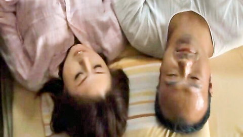 Rin Aoki and male partner lying intimately in bed, close-up faces