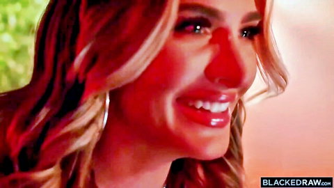 Smiling blonde beauty with glossy lips and hoop earrings closeup