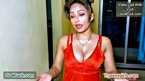 Busty Indian wife in tight red dress teases with deep cleavage and pouty lips on video call