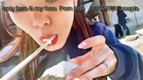 Asian babe with red hair licks thick white cum from stick outdoors in public