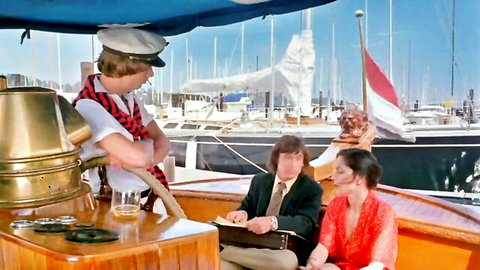 Vintage couple relaxing with drinks on a boat marina, sexy babe in red dress