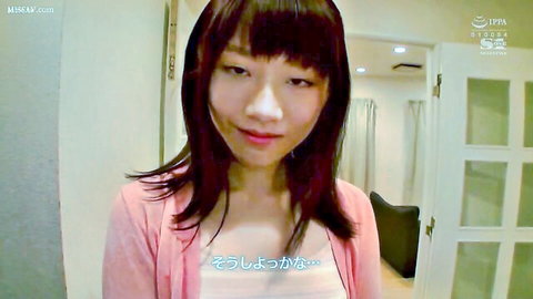 Cute Asian woman with bangs smiling in pink cardigan and white top