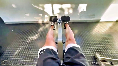 POV of muscular guy in tight Nike shorts rowing on gym machine with strong thighs