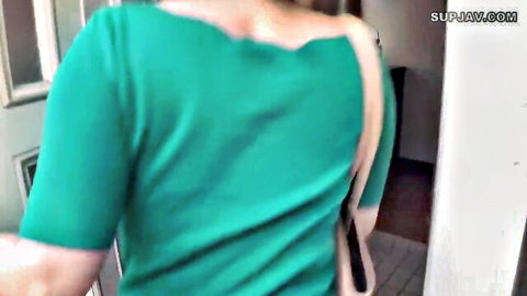MILF walks away with ripped green sweater exposing bare back and sideboob in doorway
