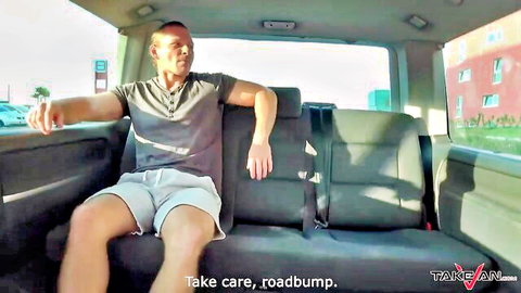 Relaxed guy in shorts lounging in van backseat during pickup adventure