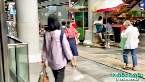 Jane in Thai street patrol: Asian women walking casually in urban market