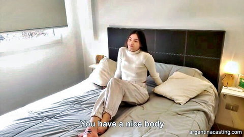 Lara 19 Argentine casting amateur in white sweater and gray pants on bed