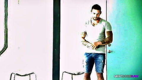 Tattooed hunk Logan Cross in white tee and ripped shorts, teasing pose