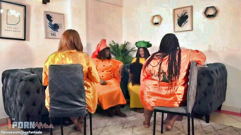 Four African ebony BBWs in colorful dresses and headwraps
