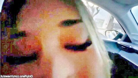 Blonde girlfriend with green eyes smiling seductively in car POV homemade