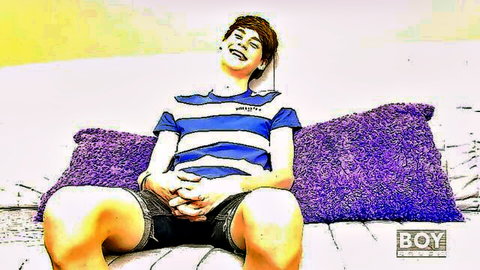 Elijah White smiling relaxed on couch in striped shirt and shorts